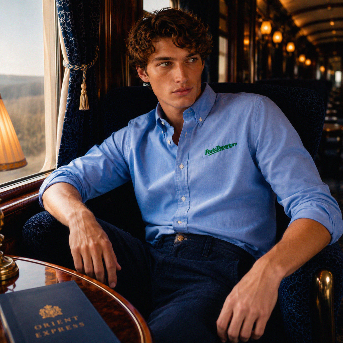Chemise Oxford Paris Departure Beauséjour Orient Express, coloris bleu Oxford, 100% coton biologique Oxford, broderie Paris Departure verte côté cœur inspirée des uniformes de voyage anciens, détail de la broderie.