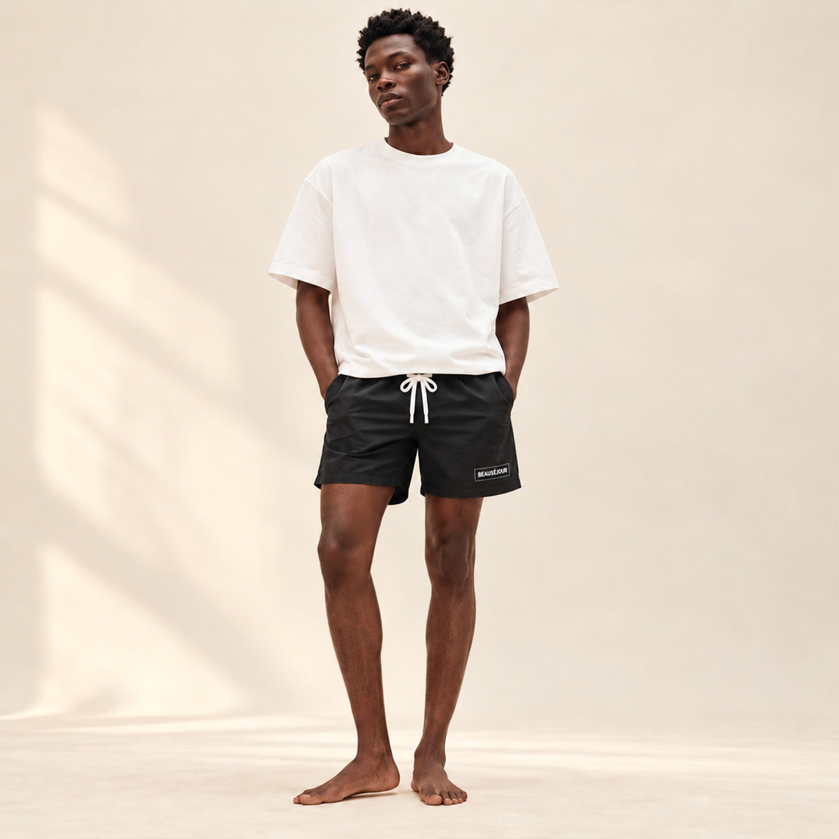 Maillot de bain noir pour homme. atch Beauséjour en caoutchouc signature sur la cuisse. Vue de face.