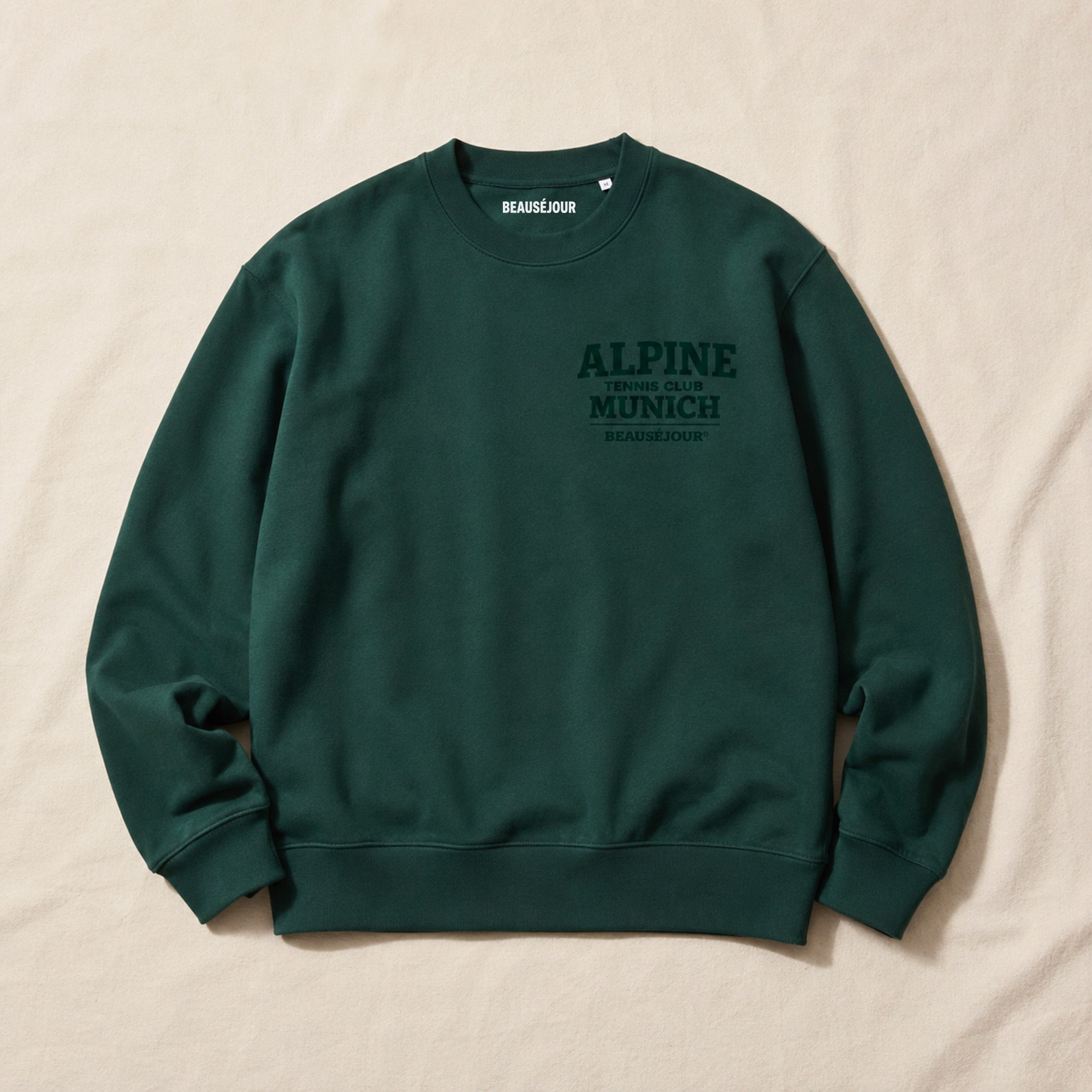 Sweat Alpine Tennis Club Munich Beauséjour® coloris vert, molleton brossé 350g/m², col rond en côte 1x1, vue de face.