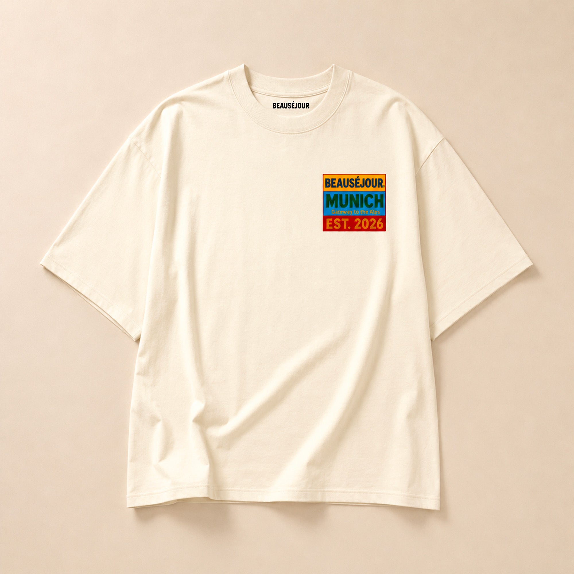 T-Shirt Boxy Gateway to the Alps Beauséjour® coloris crème, 100% coton premium 200g/m², coupe boxy oversize, vue de face.